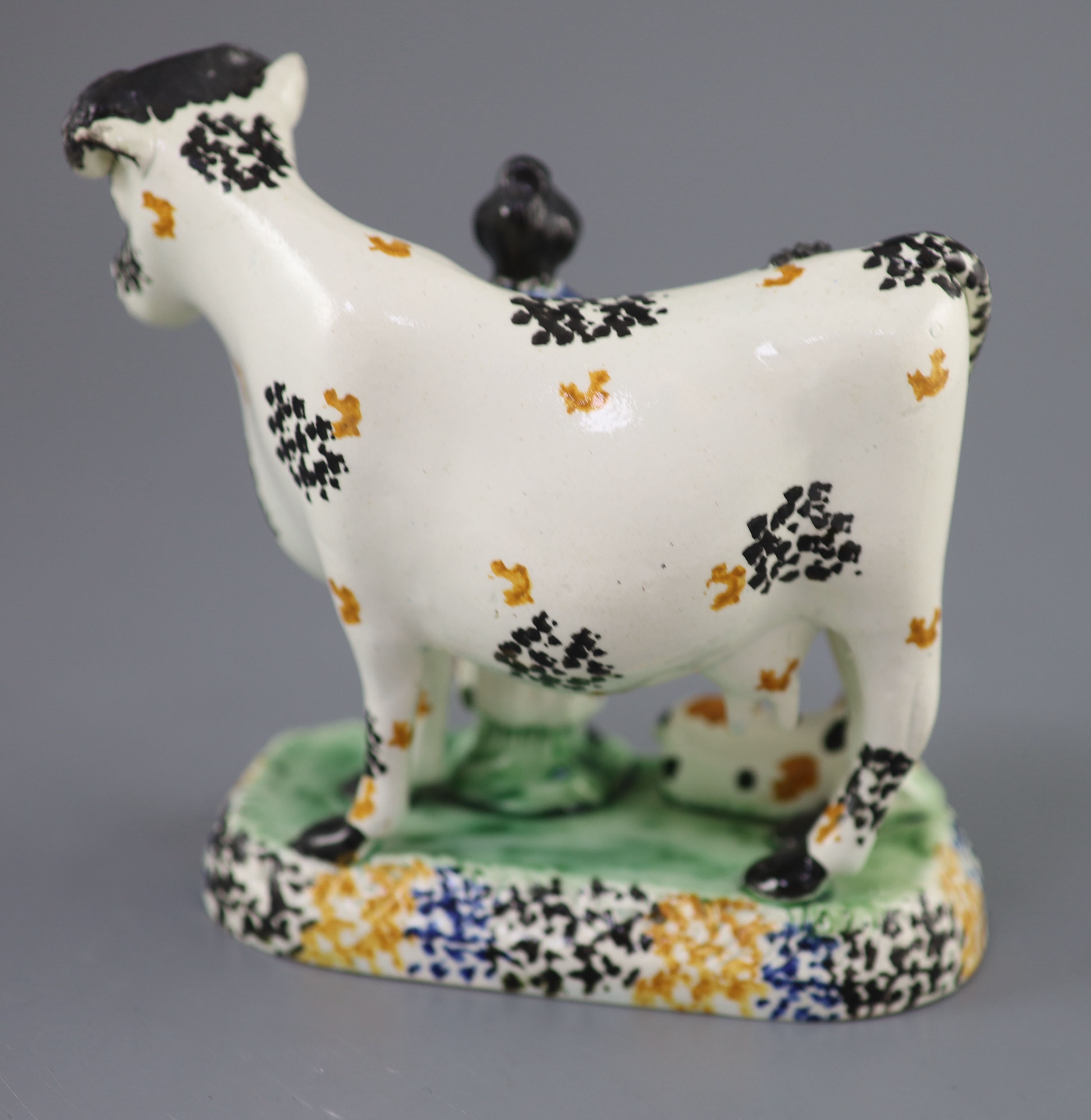 A Yorkshire Prattware cow and milkmaid group, probably Mexborough, c.1820, 15cm high, 16cm long